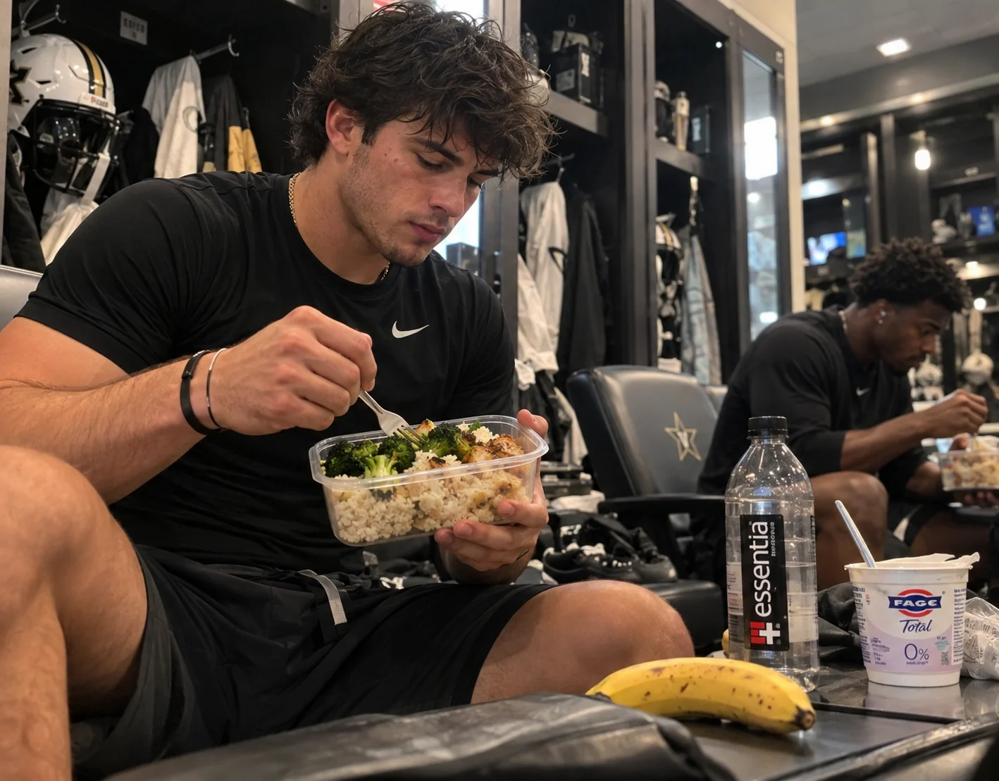 Football athlete eating a prepared rice, broccoli and chicken meal in a locker room